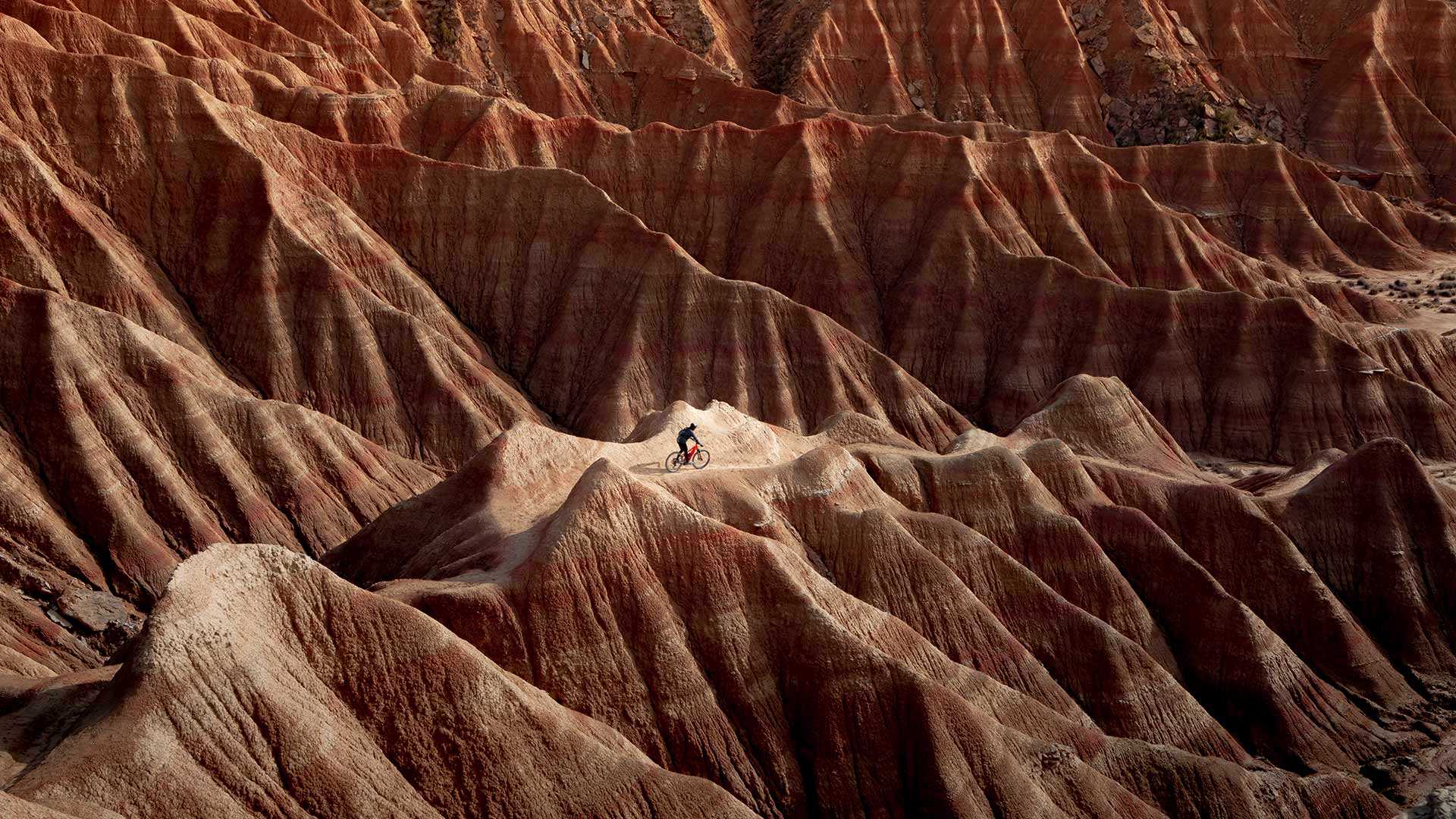 Cyclist in Bardenas Reales Natural Park and Biosphere Reserve, Navarra, Spain (© Artur Debat/Getty Images)