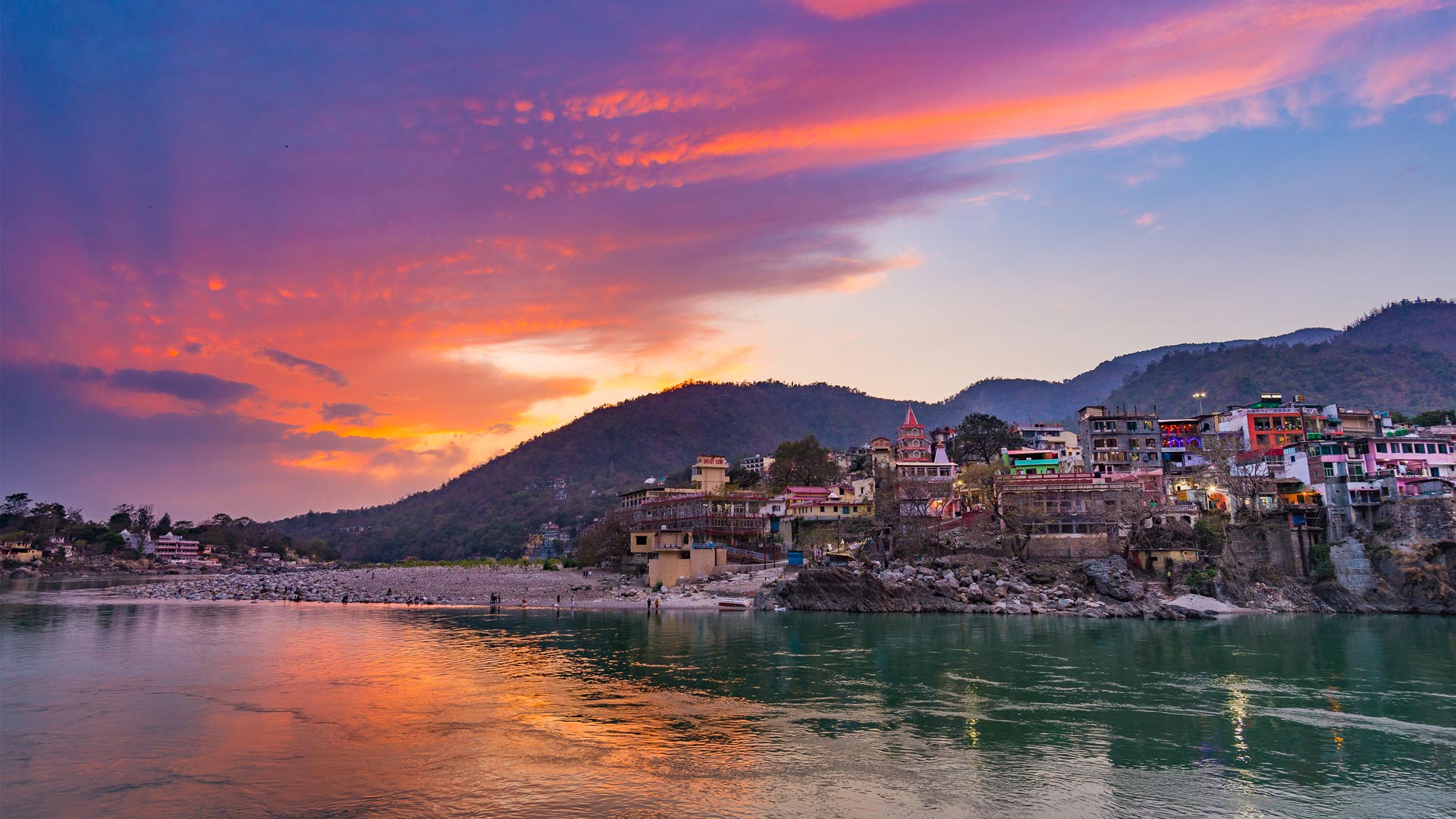 Colourful sky and clouds reflecting over the Ganges River, Rishikesh (© fbxx/iStock/Getty Images)